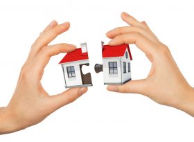 Womans hand making house puzzle isolated on white background